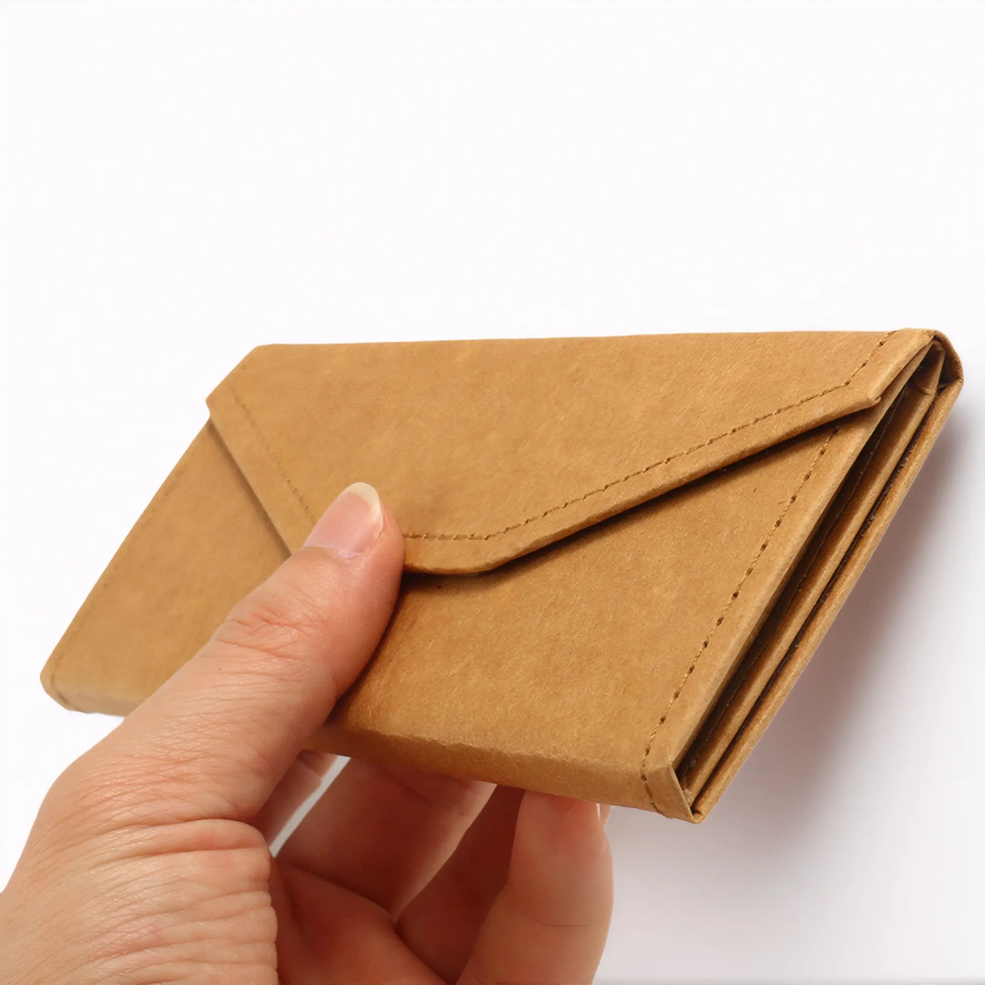 Portable eco-friendly kraft paper glasses case being held by hand